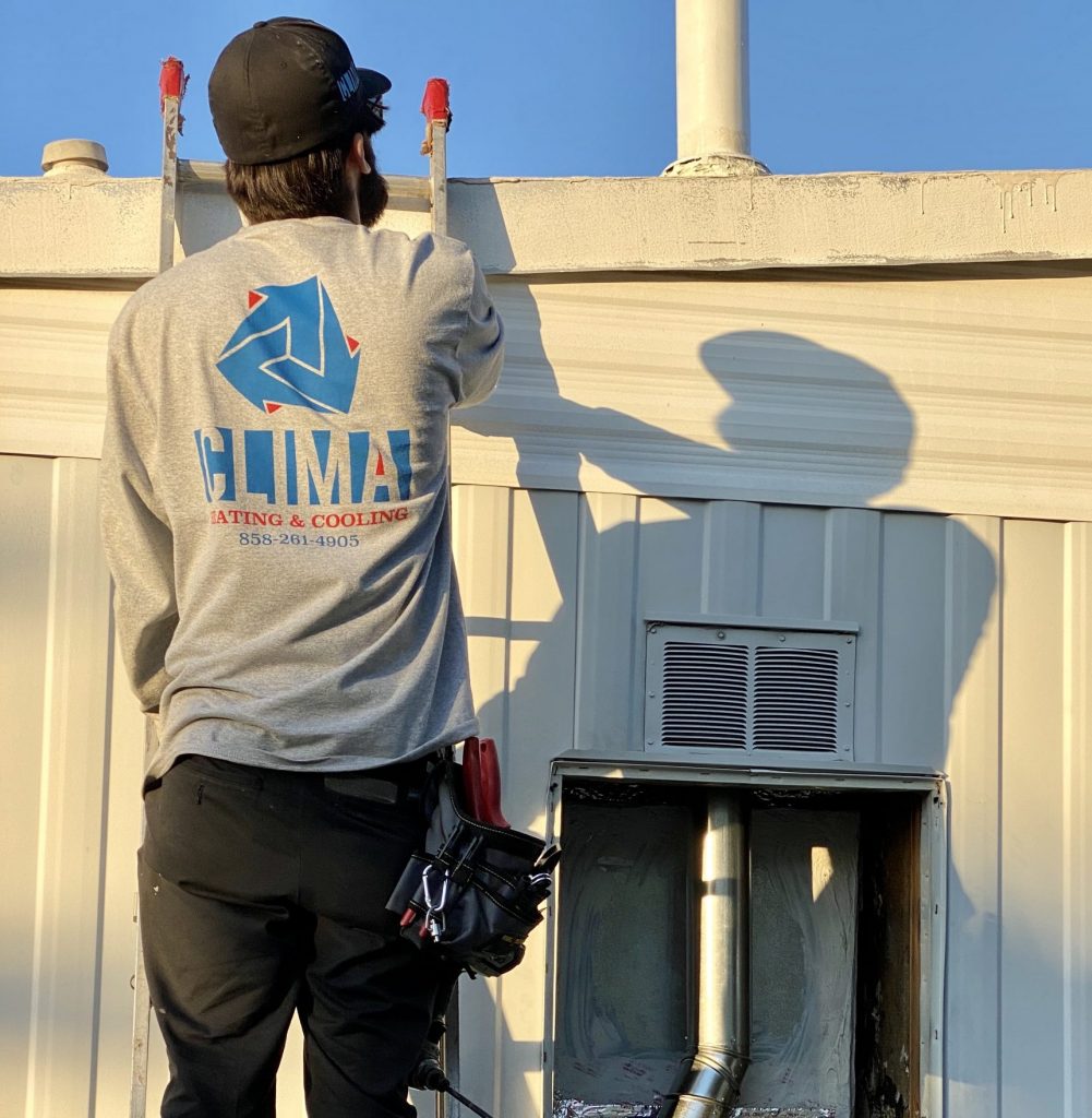 Clima Heating and Cooling technician on a ladder